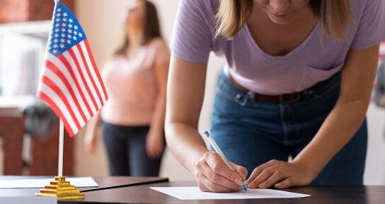  A woman signs a document